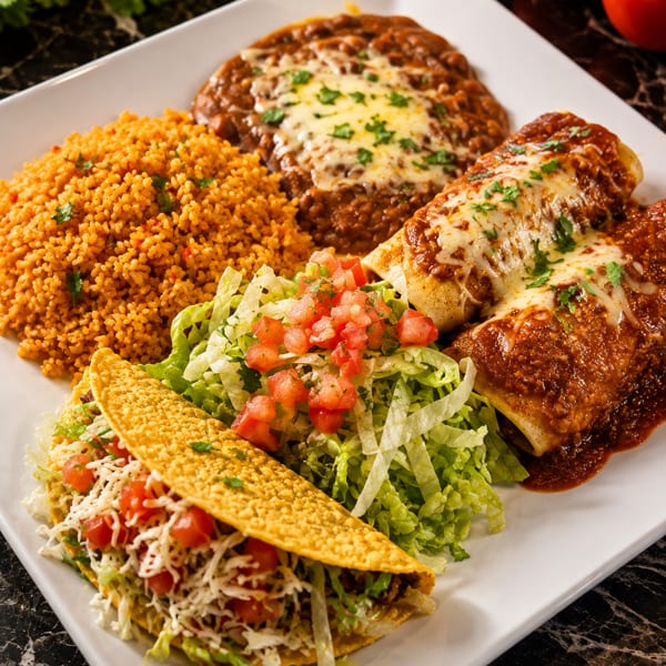 A Mexican combination platter with a taco, enchiladas, rice, refried beans, and a side salad.